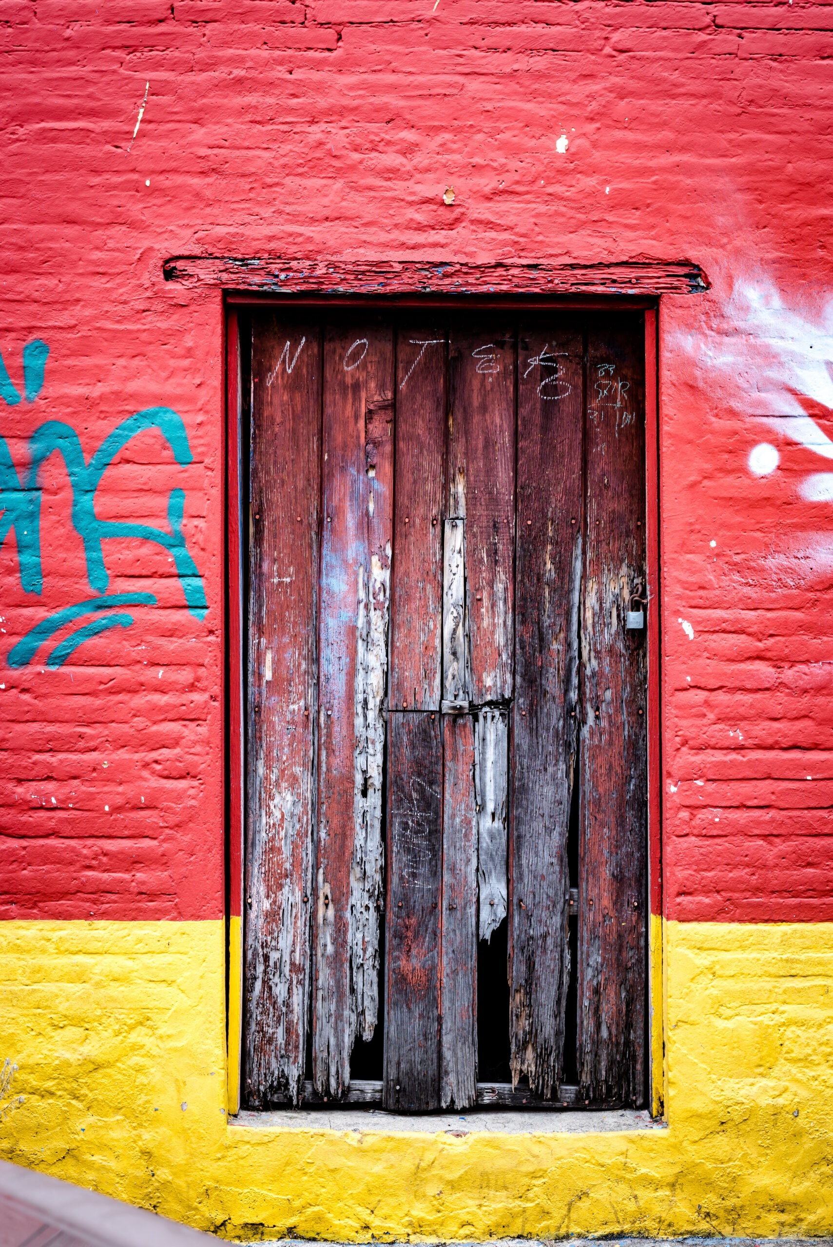 Adobe door in Huayapam, Oaxaca, layered with wood, plaster, and brick